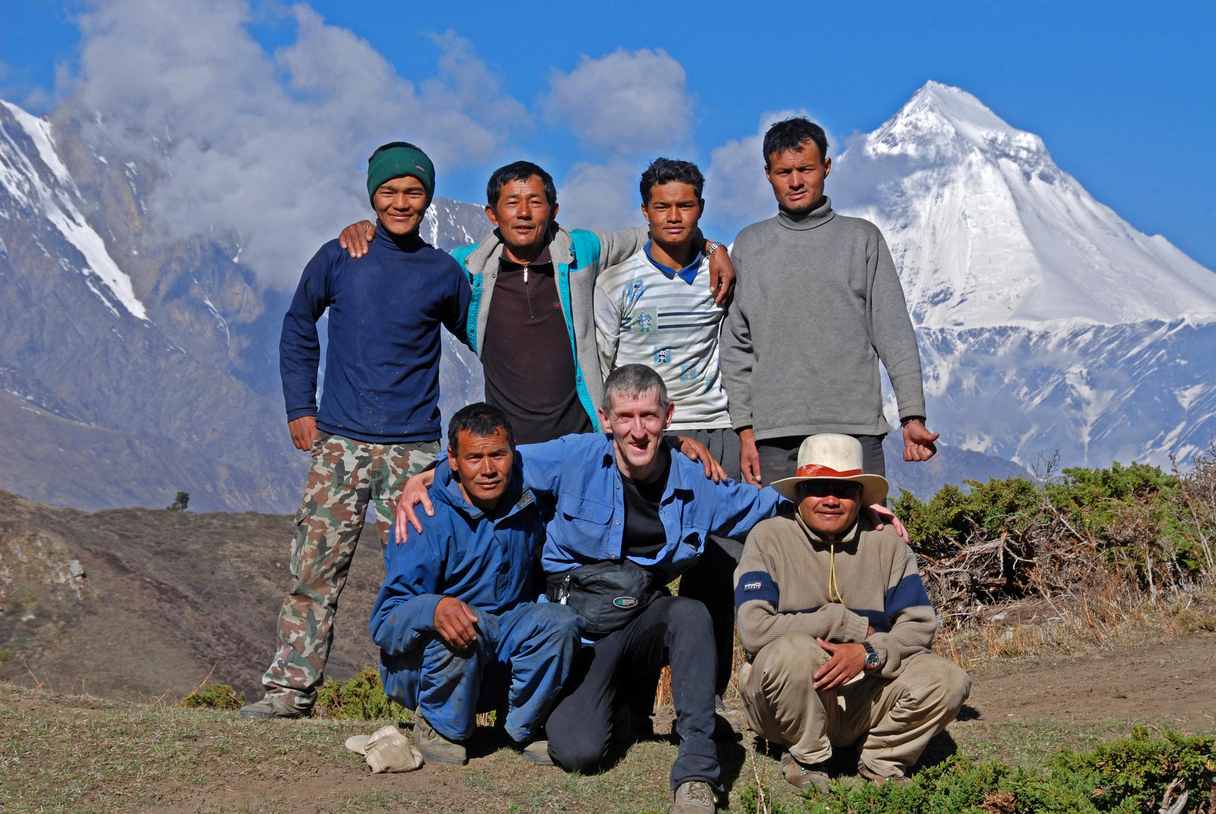 08 Team Photo On Way To Mesokanto La. Kneeling Gyan Tamang, Jerome Ryan, Kumar. Standing Tenzin, Mingma, Pemba Rinji, Nima Dorje Team photo on the way from Jomsom to Mesokanto La: kneeling down are cook Kumar, Jerome Ryan, and guide Gyan Tamang; standing are porters Tenzin and Mingma, cooks helper Pemba Rinji, and porter Nima Dorje.